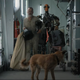 Tom Hanks, a dog, and a home-built robot walk through a high-tech bunker in a scene from Finch.